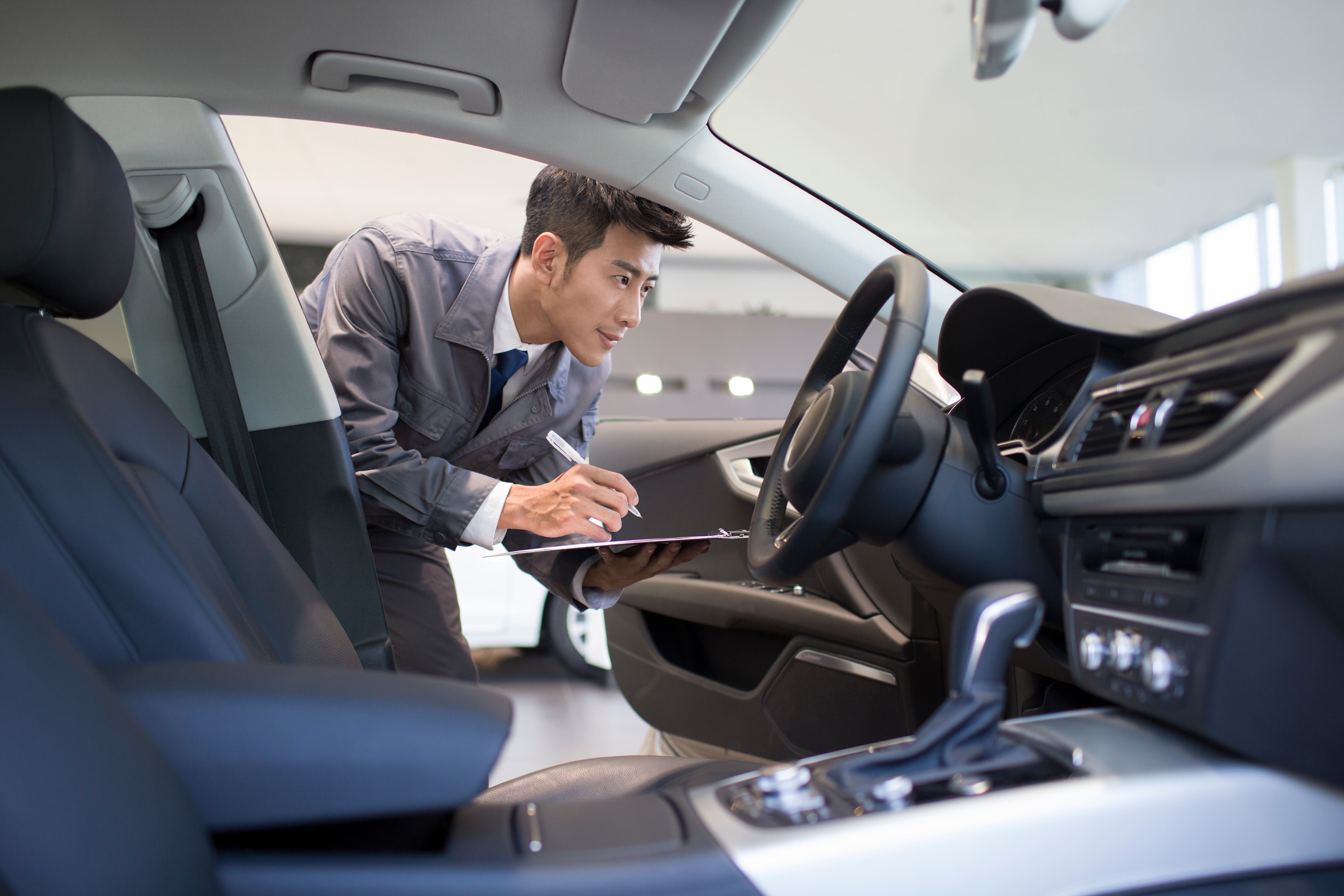 A professional checking on the inside of a car