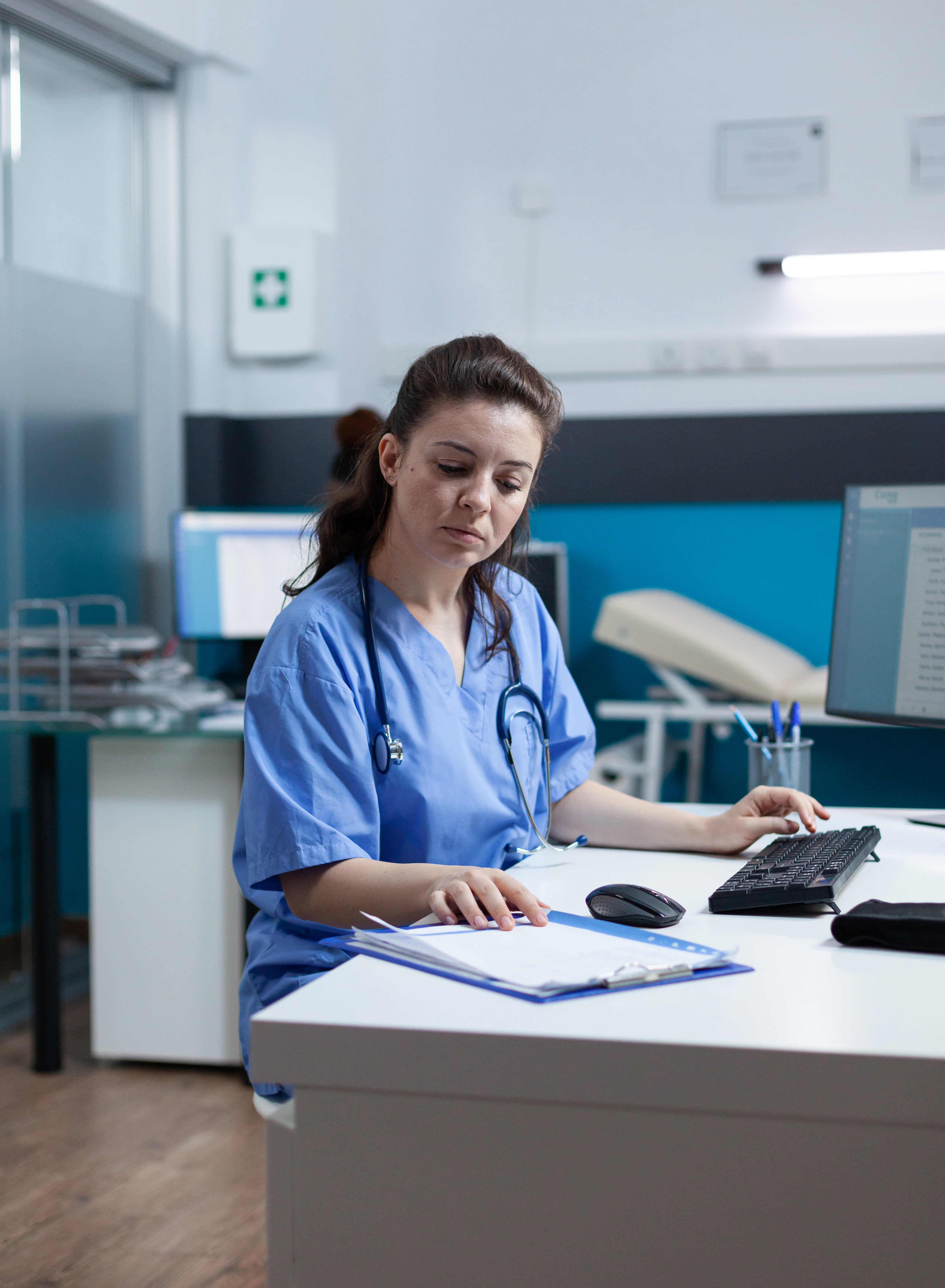 A doctor looking at a document in her office